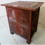 A small Eastern heavily carved box with a lift up lid and internal storage, 39cm high,