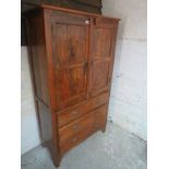 An Eastern hardwood cabinet with double panelled doors over 3 long drawers,