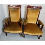 A pair of Victorian mahogany framed open sided armchairs upholstered in a gold velvet material,