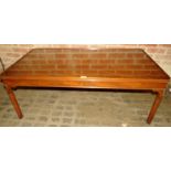 A 20th century mahogany framed coffee table with an inset glass top, in good condition,