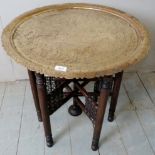 An early 20th century folding brass tray top Indian table,