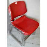 A set of four vintage red and chrome stacking chairs,