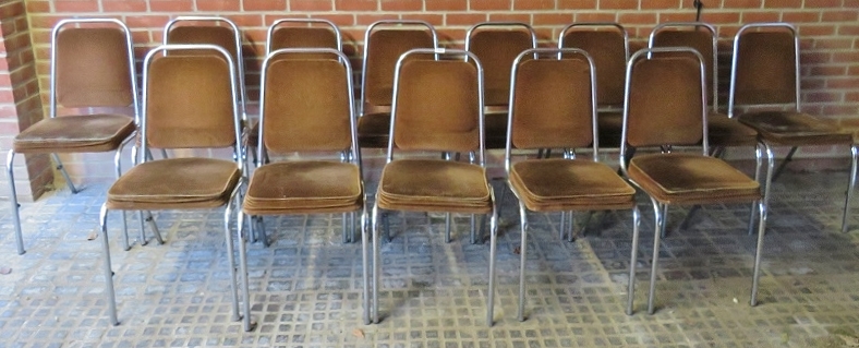 Thirteen chrome stacking chairs upholstered in a brown velour material,