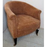 An early 20th century tub chair upholstered in a brown velour material and terminating on mahogany