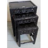 A nest of three graduated carved Chinese side tables,