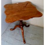 A 19th century pale mahogany butterfly top tilt top tripod table with a turned column,