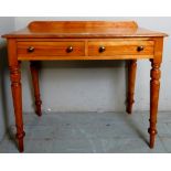 A Victorian pale two drawer hall table with a raised back gallery rail over turned legs,