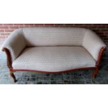 A pretty 20th century 2 seater sofa upholstered in a cream material with small pink flowers,
