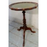 A small mahogany 20th century wine table with a tooled green leather top and turned column,