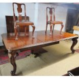 A large Victorian mahogany extending dining table with 4 extra leaves,