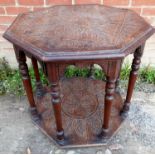 A 19th Century carved oak octagonal centre table with turned legs and a lower shelf,