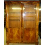 A fine 19th century walnut double cabinet with glazed doors opening to reveal internal shelves of