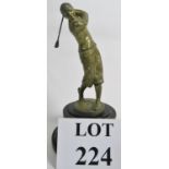 A car mascot in the form of a golfer on