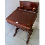 A Victorian walnut Davenport desk with a lockable stationery compartment to top over a fall front