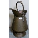 A large copper and brass jug with a blue