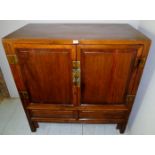 A 20th century Chinese 2 door cupboard w