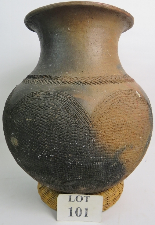 An ethnic pottery storage jar with incis