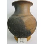 An ethnic pottery storage jar with incis