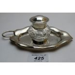A silver inkwell, well base in the shape