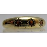 A 9ct gold three stone garnet ring, size