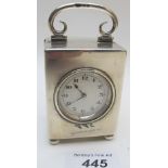 A silver cased travelling/mantle clock o