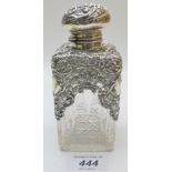 A silver scent bottle with silver hinged