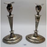 A pair of silver candlesticks in classic