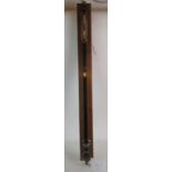 A vintage ebonised metal and brass stick barometer, number 6093, with manufacturers plaque,