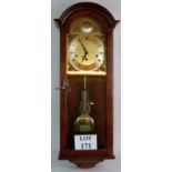 A glazed mahogany cased chiming wall clock by Comitti of London, with key and pendulum,