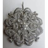 A diamond encrusted 'snowflake' pendant, possibly 18ct white gold,