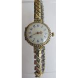 An 18ct gold ladies wristwatch with enamelling and set with seed pearls,