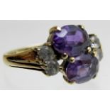A 9ct gold two stone amethyst and four white stone ring, size K,