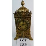 A fine ornate antique cast brass cased mantle clock with pineapple finial's, 32cm tall,