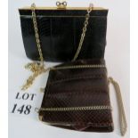 Two vintage snakeskin handbags with gilt chains and hardware, one in black, the other in dark brown,