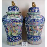 A pair of large and impressive Chinese porcelain floor vases and domed covers with gilt Temple Dog