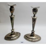 A pair of silver candlesticks in classical style, approx 11" high, London 1906,