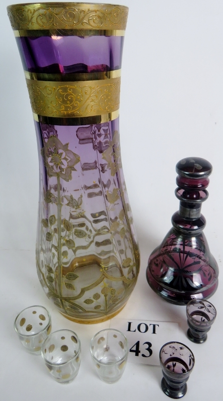 A tall glass vase with a floral pattern in silver & gilt clear at the base blending to purple at