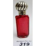 A cranberry coloured scent bottle with silver top est: £50-£70