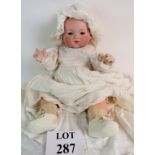 An early 20th century Armand Marseille bisque head doll, 311/8k, with body and clothing, 52cm high,