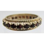 A 9ct gold full garnet eternity ring,