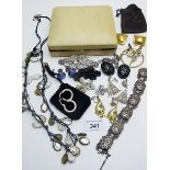 An assortment of costume jewellery to include a pair of silver hoop earrings,