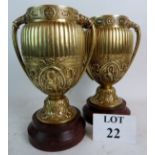 A pair of heavy quality late 19th century Classical-Revival gilt metal urns on rouge marble bases,