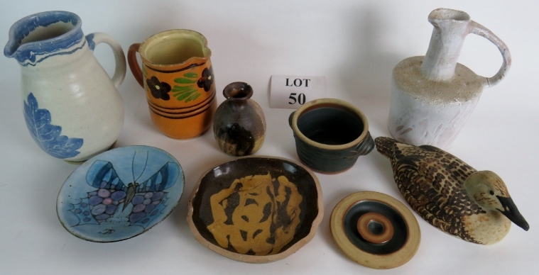 Several items of studio pottery from various makers to include a stoneware cider Jack, three jugs,