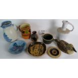 Several items of studio pottery from various makers to include a stoneware cider Jack, three jugs,
