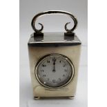 A silver cased travelling/mantle clock on ball feet, London 1924, Goldsmith's & Silversmith's Co,