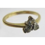 An 18ct gold three stone diamond ring, size J,