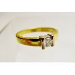 An 18ct yellow and white gold diamond solitaire ring, size N,