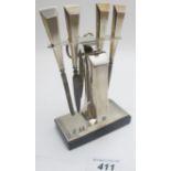 An Art Deco silver manicure set on stand, comprising five items, and a pair of associated scissors,