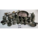 An extensive collection of early continental pewter to include mustard pots, pepper pots, a quaich,