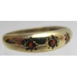 A 9ct gold three stone garnet ring, size M,